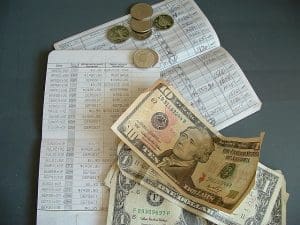 Book logging payments with money on top